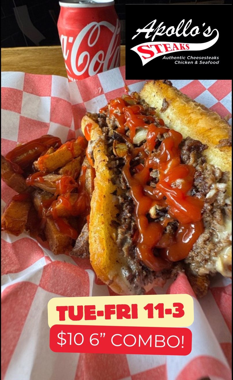 Apollo's Steaks cheesesteak with fries and ketchup, next to a Coca-Cola can.